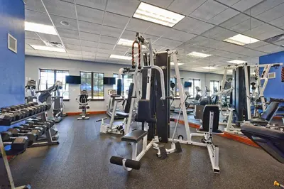a gym with lots of tread machines and weights at Pvt Splashpool, Bbq Grill, Close To Parks-3057Pp in Kissimmee