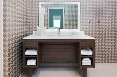a bathroom with a sink and a mirror at Home2 Suites By Hilton Orlando Near Universal in Orlando