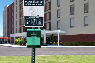 a sign on a pole in front of a building at Home2 Suites By Hilton Orlando Near Universal in Orlando