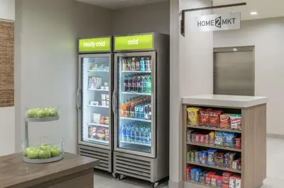 a store with two refrigerators in a store at Home2 Suites By Hilton Orlando Airport in Orlando