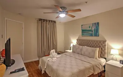 a bedroom with a bed and a ceiling fan at Disney Adjacent in Kissimmee