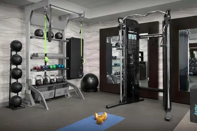 a room with a gym with a dog on the floor at Homewood Suites by Hilton Orlando Airport in Orlando