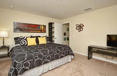 a bedroom with a bed and a flat screen tv at South Facing Pool Wsplashpool- 3080Pp in Kissimmee