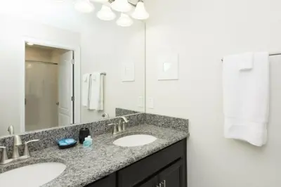 a bathroom with two sinks and a large mirror at Perfect Townhome for your Vacation with Private Pool SL4807 in Kissimmee
