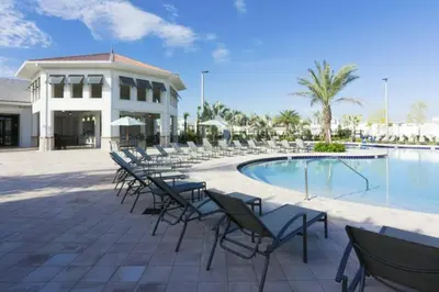 a group of chairs sitting next to a swimming pool at Perfect Townhome for your Vacation with Private Pool SL4807 in Kissimmee
