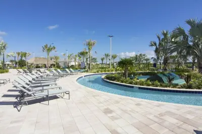 a pool at a resort with lounge chairs and palm trees at Perfect Townhome for your Vacation with Private Pool SL4807 in Kissimmee