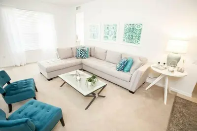 a living room with a couch and a table at Modern Vacation Apartment with a Lake View in Orlando