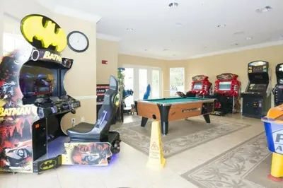 a room with arcade games and a pool table at Modern Vacation Apartment with a Lake View in Orlando