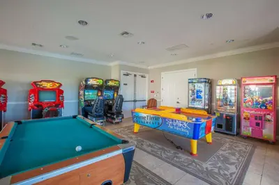 a games room with a pool table and arcade machines at Gorgeous Apartment in Orlando at Vista Cay Resort in Orlando