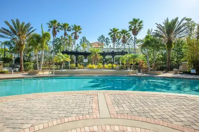 a large swimming pool with palm trees in the background at Gorgeous Apartment in Orlando at Vista Cay Resort in Orlando