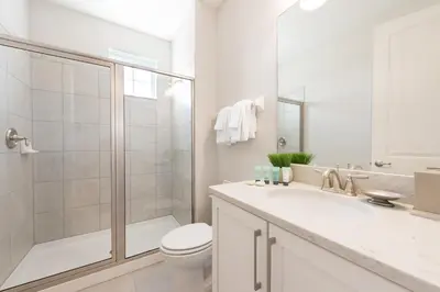 a bathroom with a shower and a toilet and a sink at Gorgeous Home With Private Pool, Themed Rooms Near Disney With Waterpark & Resort Access At Encore Resort - 7687Ff in Kissimmee