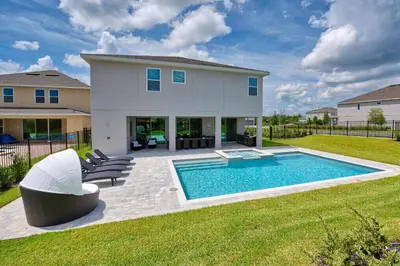 a backyard with a swimming pool and a house at Gorgeous Home With Private Pool, Themed Rooms Near Disney With Waterpark & Resort Access At Encore Resort - 7687Ff in Kissimmee