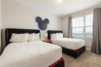 a bedroom with two beds and an apple sign on the wall at Gorgeous Home With Private Pool, Themed Rooms Near Disney With Waterpark & Resort Access At Encore Resort - 7687Ff in Kissimmee