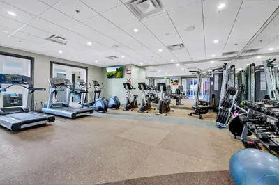 a gym with treadmills and machines in a room at Gorgeous Home With Private Pool, Themed Rooms Near Disney With Waterpark & Resort Access At Encore Resort - 7687Ff in Kissimmee