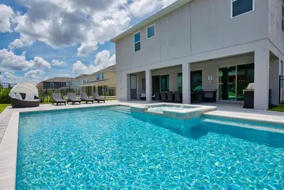 a swimming pool in front of a house at Gorgeous Home With Private Pool, Themed Rooms Near Disney With Waterpark & Resort Access At Encore Resort - 7687Ff in Kissimmee