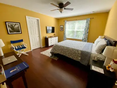 a bedroom with a bed and a ceiling fan at Beautiful Hollywood style home next to Disney in Kissimmee