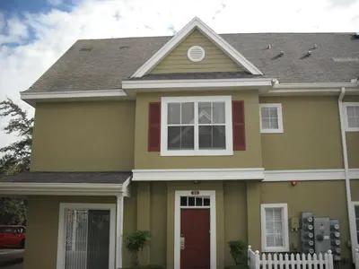 a green house with a brown roof at Venetian Bay Villa 4 Bedroom Townhouse - Near Disney in Kissimmee