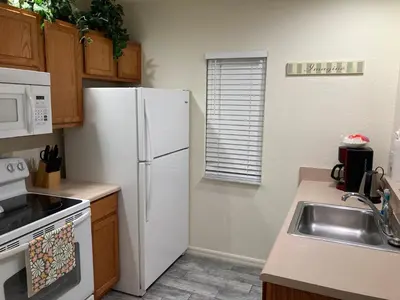 a kitchen with a white refrigerator and a sink at Venetian Bay Villa 4 Bedroom Townhouse - Near Disney in Kissimmee