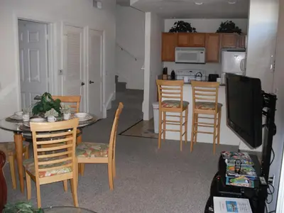 a kitchen and dining room with a table and chairs at Venetian Bay Villa 4 Bedroom Townhouse - Near Disney in Kissimmee