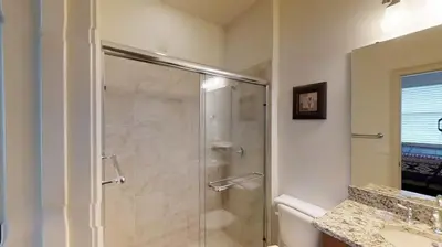 a bathroom with a glass shower with a sink at 6 Bed, 4 Bath perfect for group or large family in Oviedo