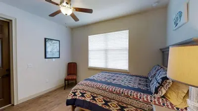 a bedroom with a bed and a ceiling fan at 6 Bed, 4 Bath perfect for group or large family in Oviedo