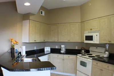a kitchen with a sink and a stove top oven at WQR Private Rentals No Resort Pool Access in Orlando