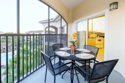 a balcony with a table and chairs on a balcony at WQR Private Rentals No Resort Pool Access in Orlando