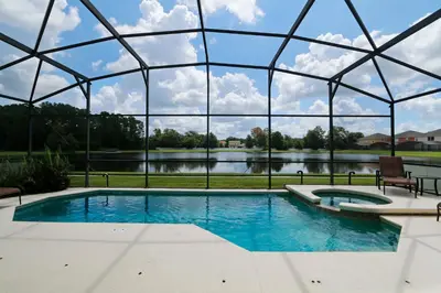 a large swimming pool with a glass dome at Seasons Villa 6 bedrooms, 4 masters and water view in Kissimmee