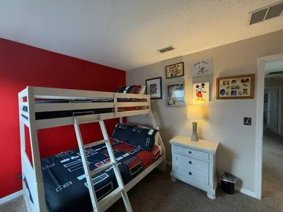 a bedroom with two bunk beds and a night stand at Seasons Villa 6 bedrooms, 4 masters and water view in Kissimmee