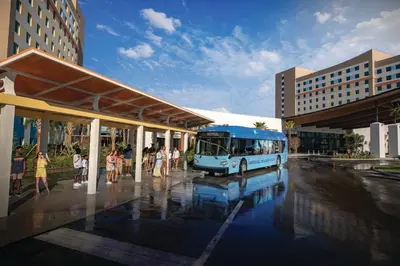 a blue bus is parked at a bus stop at Universal’s Endless Summer Resort – Dockside Inn and Suites in Orlando