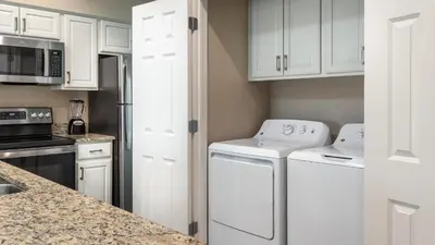 a kitchen with white cabinets and white appliances at Holiday Inn Club Vacations At Orange Lake Resort in Orlando
