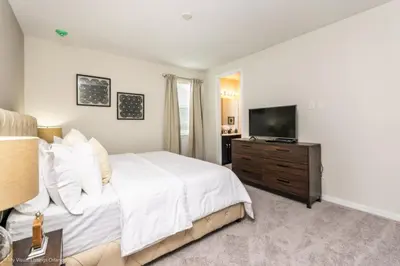 a bedroom with a bed and a flat screen tv at Sunshine Ridge Loop Villa #258891 Villa in Orlando