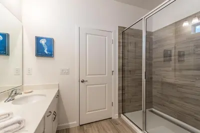 a bathroom with a glass shower and a sink at Calistoga Avenue Villa #259830 Villa in Kissimmee