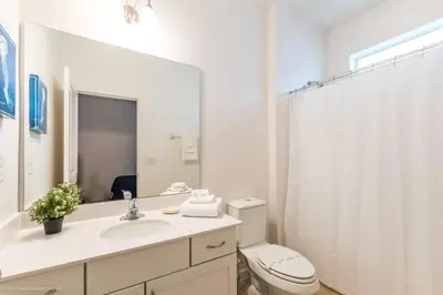 a bathroom with a sink and a toilet and a mirror at Calistoga Avenue Villa #259830 Villa in Kissimmee