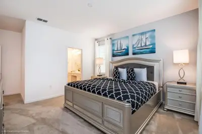 a bedroom with a bed with a black and white comforter at Calistoga Avenue Villa #259830 Villa in Kissimmee