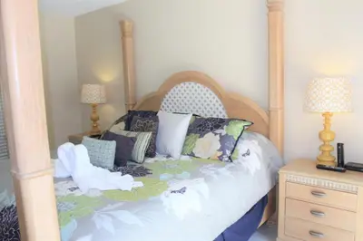 a bedroom with a canopy bed with pillows at Lindfields Reserve #267170 Villa in Kissimmee