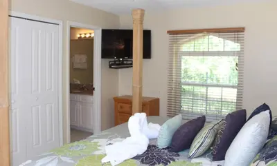a bedroom with a bed with swans on it at Lindfields Reserve #267170 Villa in Kissimmee
