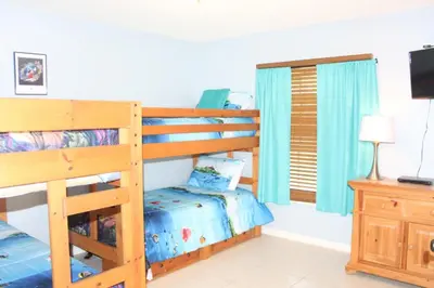 a bedroom with two bunk beds and a television at Lindfields Reserve #267170 Villa in Kissimmee