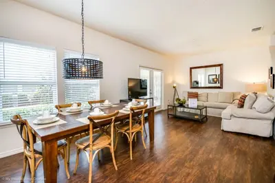 a dining room and living room with a table and chairs at Lucaya Village Resort Townhome Unit 14 Townhouse in Orlando