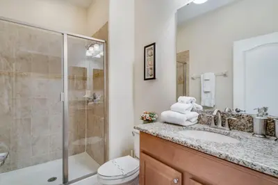 a bathroom with a shower and a sink and a toilet at Cuban Palm Townhouse #275805 Townhouse in Kissimmee