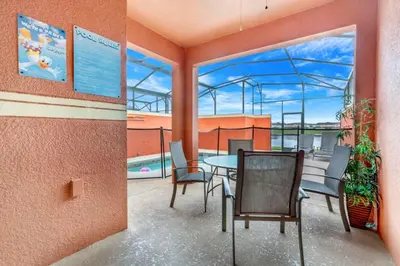 a patio with a table and chairs on a balcony at Cuban Palm Townhouse #275805 Townhouse in Kissimmee