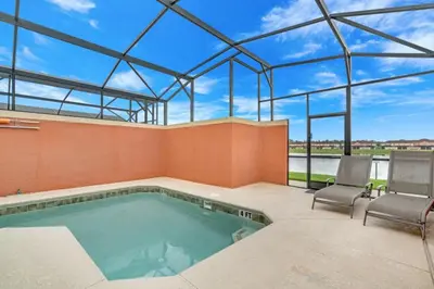 a swimming pool in a house with a glass ceiling at Cuban Palm Townhouse #275805 Townhouse in Kissimmee