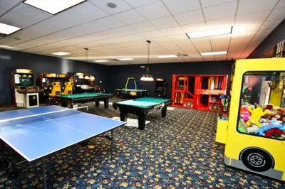 a gaming room with two ping pong tables and a pool table at Cuban Palm Townhouse #275805 Townhouse in Kissimmee