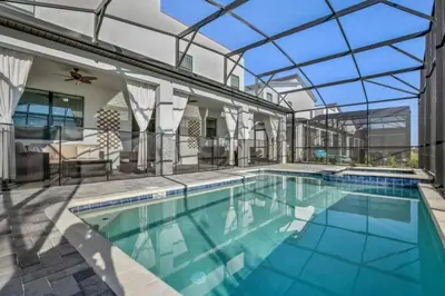 an indoor swimming pool with a glass ceiling at 2901FS - Amazing 8 bedroom at Storey Lake in Kissimmee