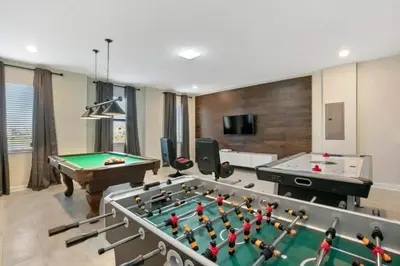a living room with a pool table and ping pong balls at 2901FS - Amazing 8 bedroom at Storey Lake in Kissimmee