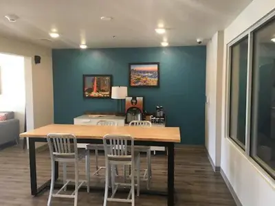 a dining room with a table and chairs at Woodspring Suites Orlando International Drive in Orlando