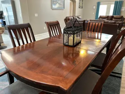 a wooden table with a lantern on top of it at House By the Mouse in Kissimmee