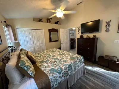 a bedroom with a bed and a flat screen tv at House By the Mouse in Kissimmee