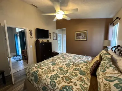 a bedroom with a bed and a ceiling fan at House By the Mouse in Kissimmee