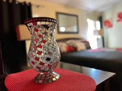 a mosaic vase sitting on top of a red table at House By the Mouse in Kissimmee